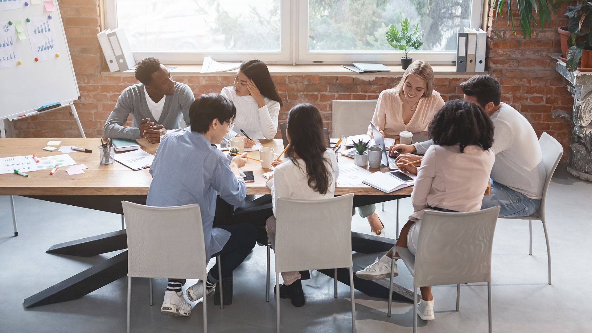 Business meeting of young creative people, office interior