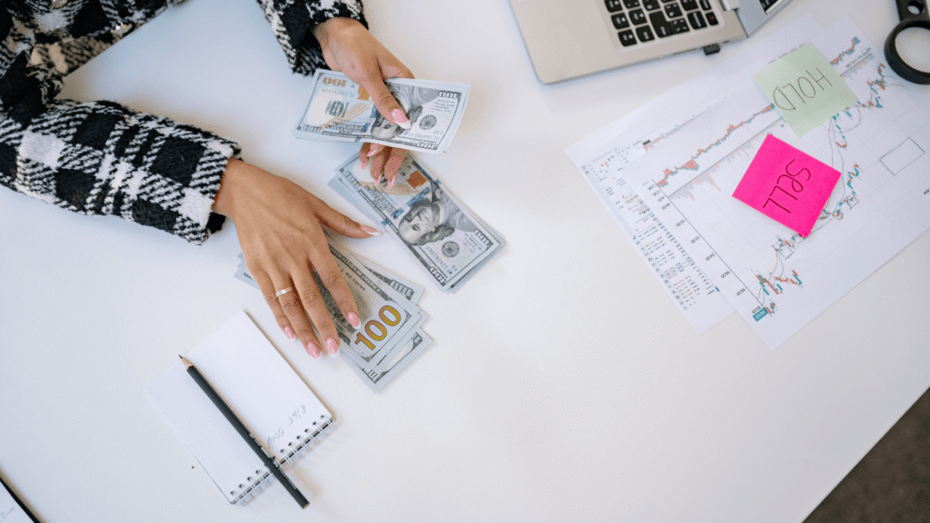 Storage facility owner counting cash on a table.
