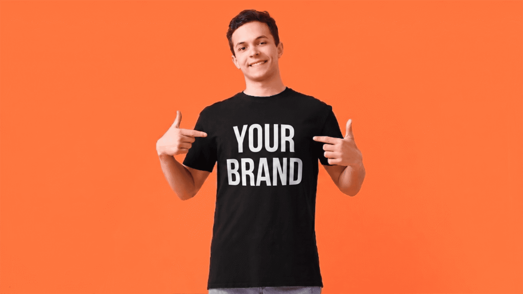 Person pointing to “Your Brand” shirt representing self storage branding identity and brand awareness.