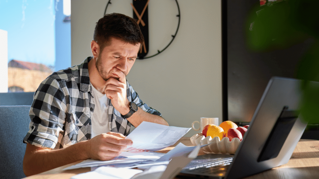 Man reviewing financial documents while analyzing a self storage investment deal